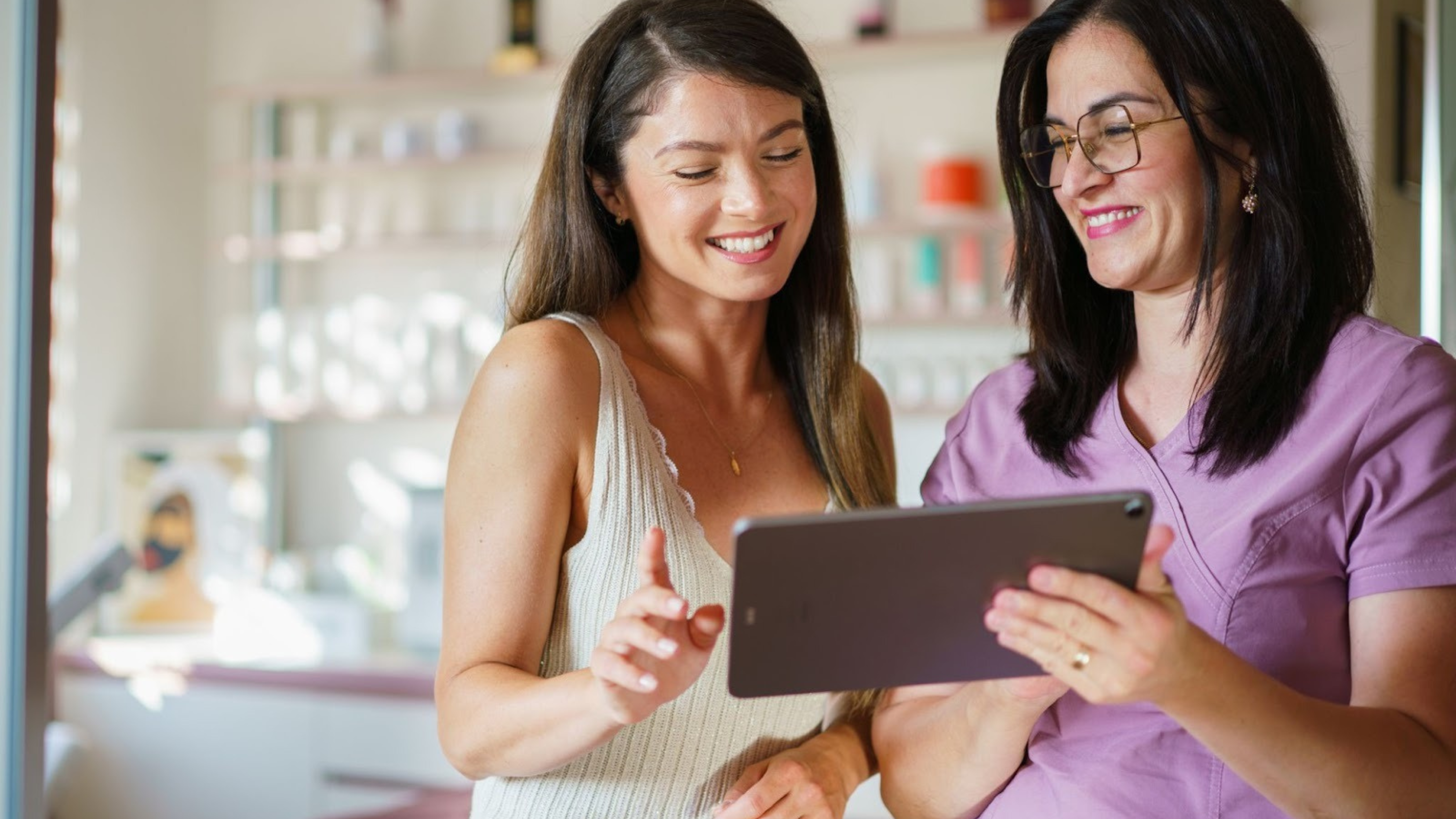 Aesthetic provider reviewing treatment and monthly payment options with a patient, illustrating how flexible payments increase acceptance without discounting.