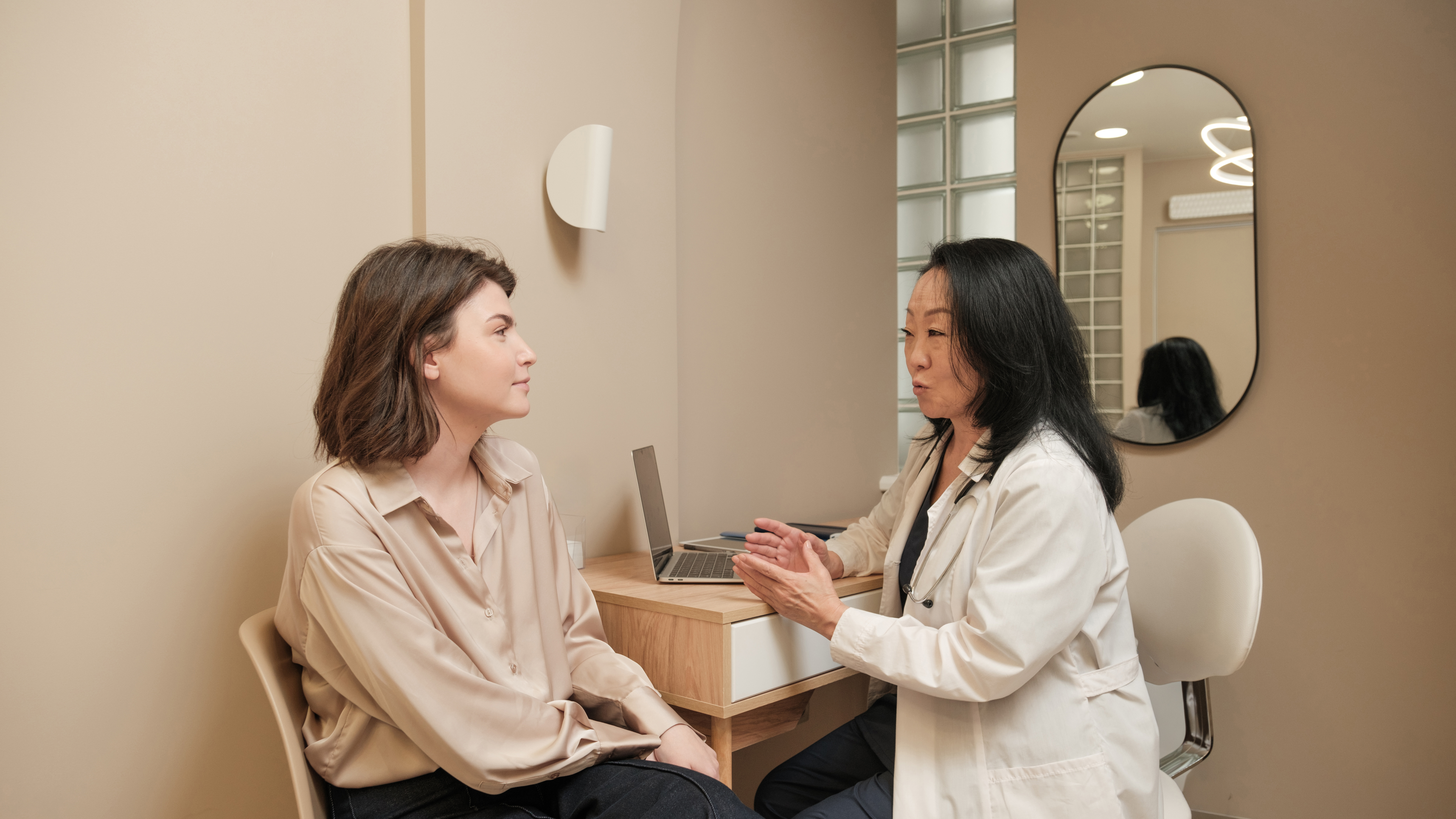 Aesthetic provider discussing treatment costs and options with a patient